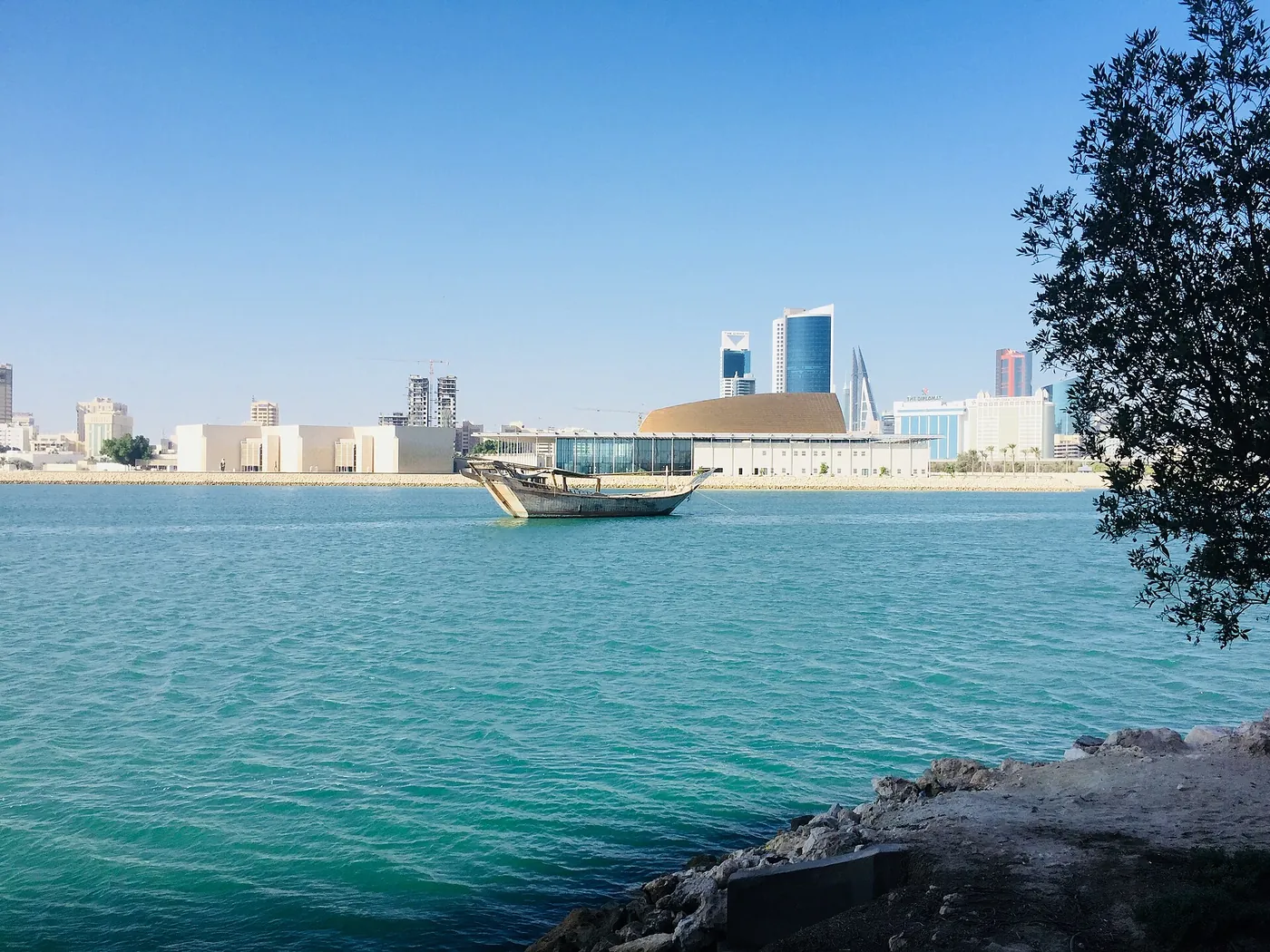 A wooden dhow beside the Bahrain National Museum